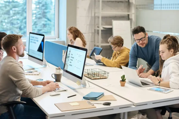 a group of people sitting around a table in a meeting
