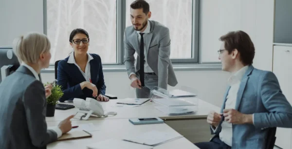 Group of professionals in a modern office setting discussing business strategies