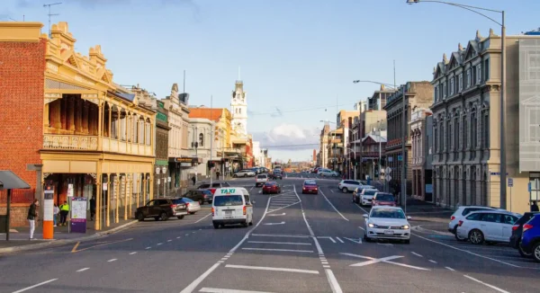 Vibrant main street of a regional Victorian town featuring historic architecture, active traffic, and local businesses reflecting regional growth, community infrastructure, and decentralised development opportunities.