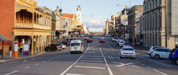 Vibrant main street of a regional Victorian town featuring historic architecture, active traffic, and local businesses reflecting regional growth, community infrastructure, and decentralised development opportunities.